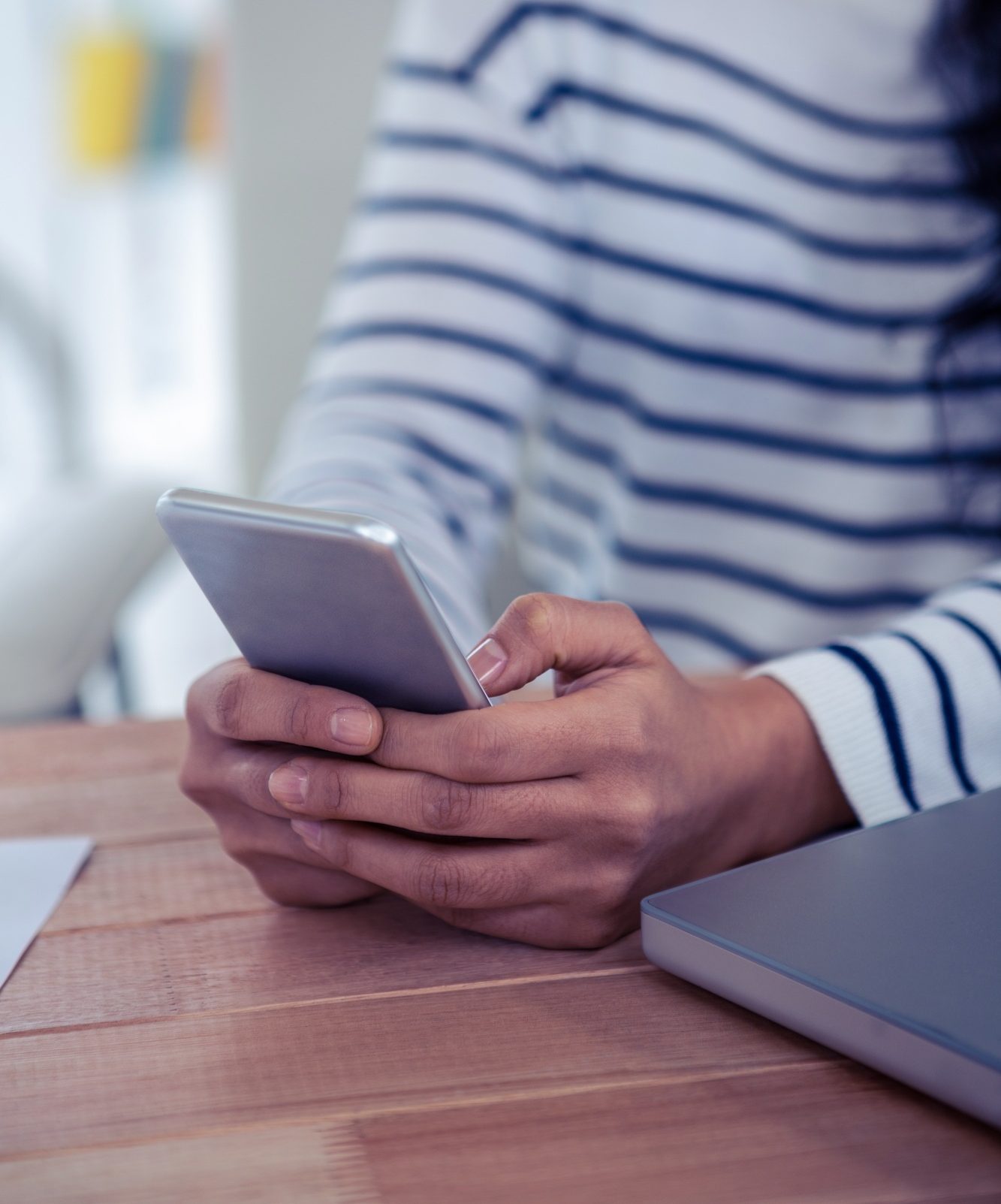 Close up of woman using smartphone in office